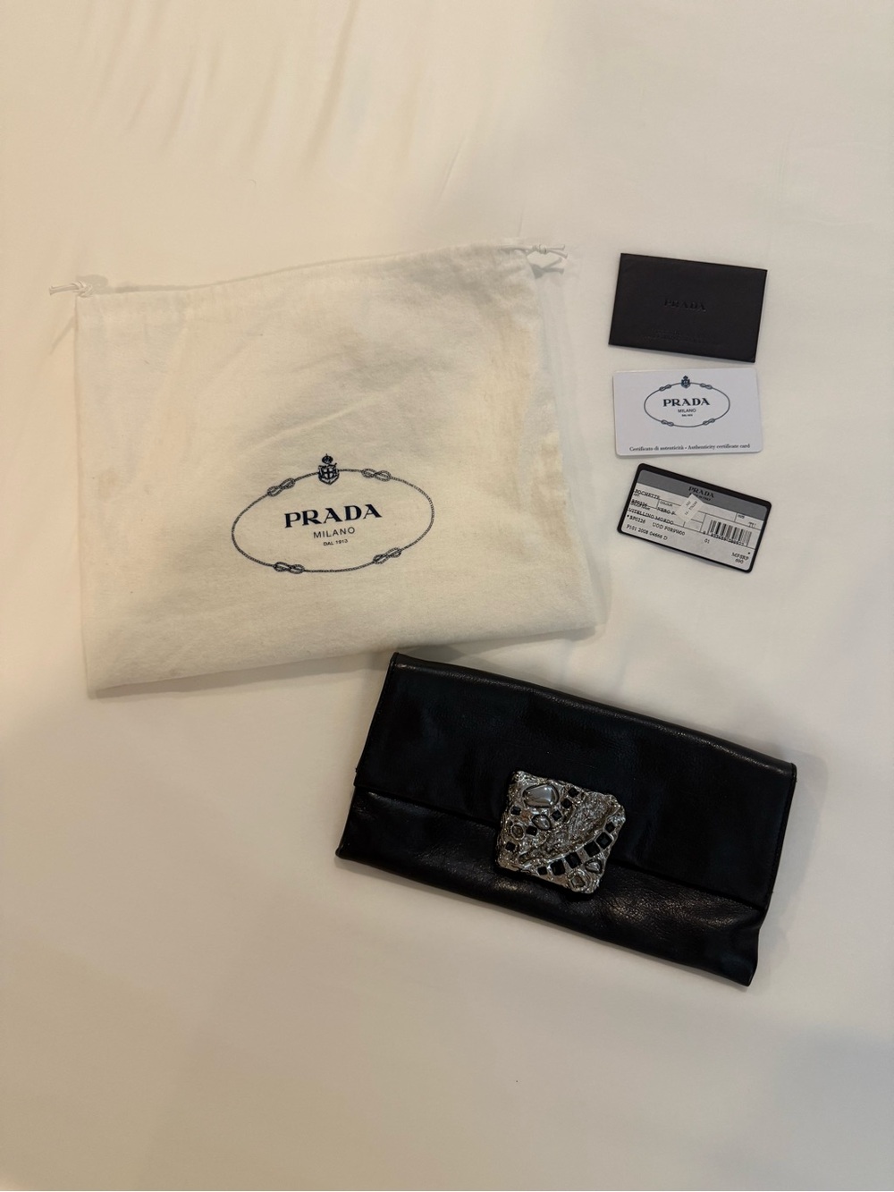 Prada Black Leather Clutch with Ornate Silver Jewel Accent